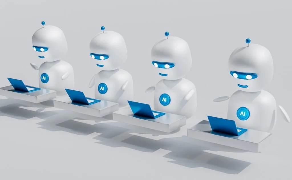A Group Of White Robots Sitting On Top Of Laptops