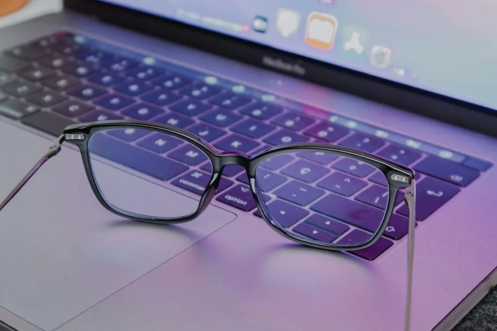 A Pair Of Glasses Sitting On Top Of A Laptop Keyboard