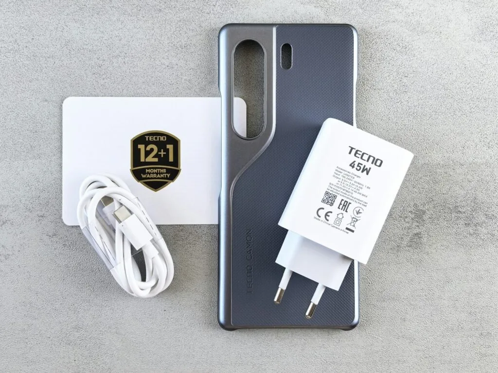 Phone, Charger, And Accessories Are Neatly Arranged.