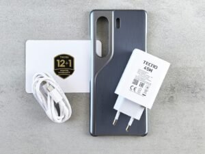 Phone, charger, and accessories are neatly arranged.