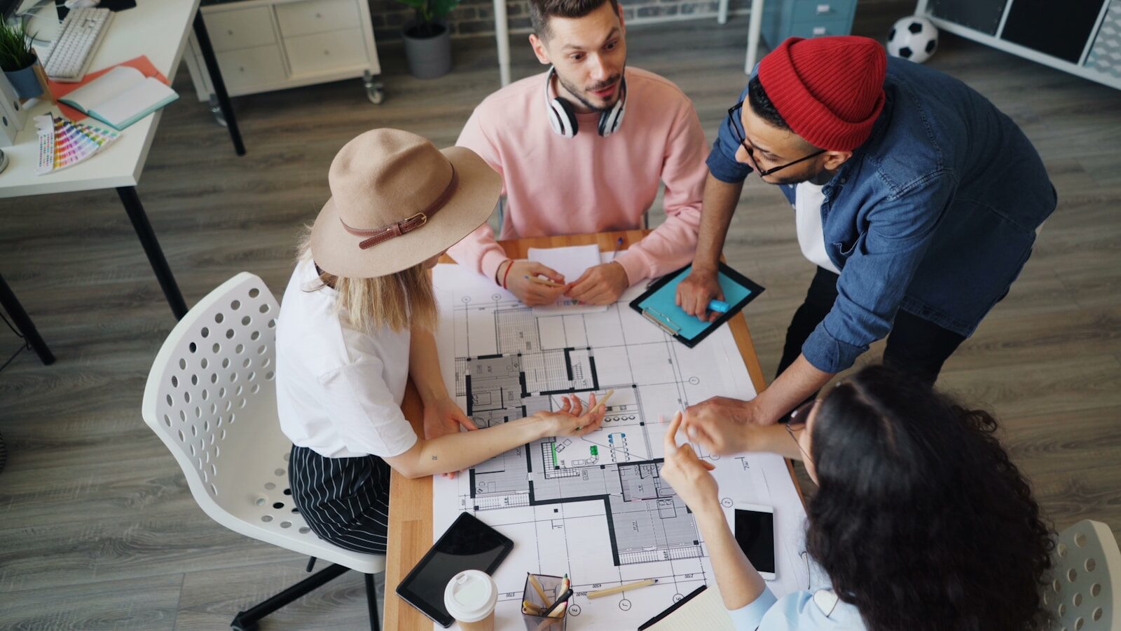 a group of people sitting around a table playing a board game