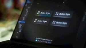Laptop screen displays four button style options.