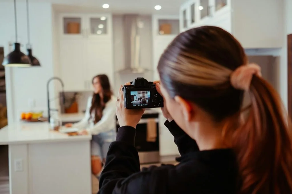A Woman Taking A Picture Of Herself In A Kitchen
