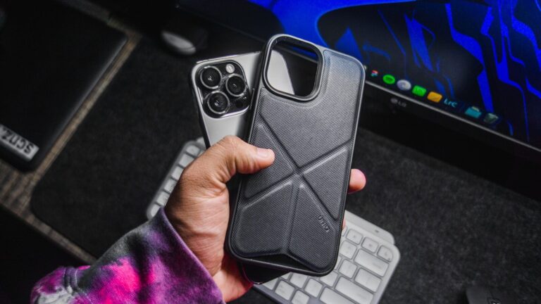 A Person Holding A Cell Phone In Their Hand